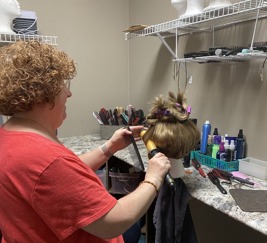 A Hair Response specialist styling a client's hair piece