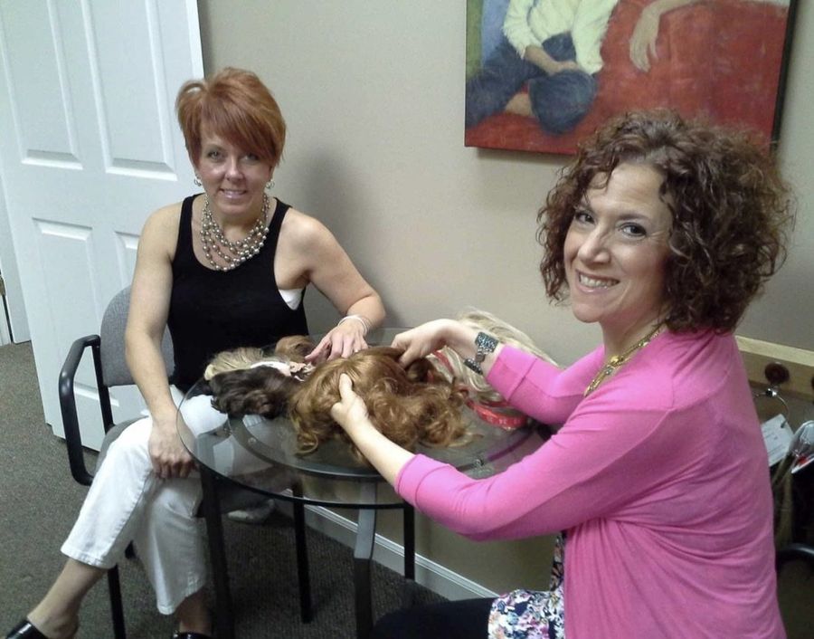 Amy fitting a hair piece with a client at Hair Response in Arlington Heights