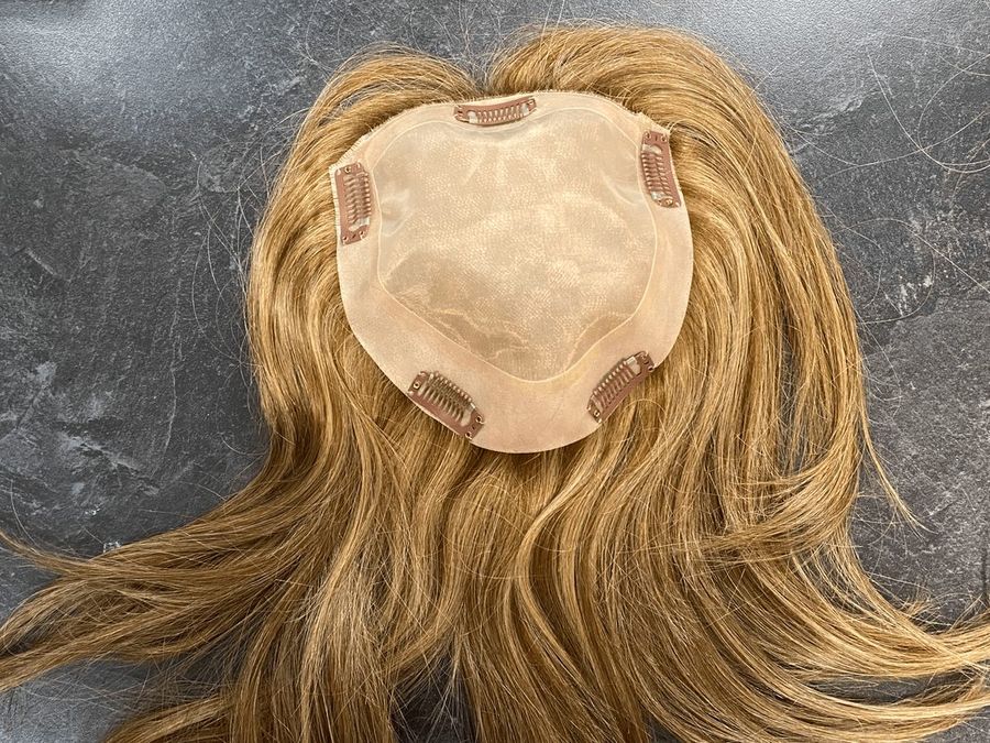 Close-up of a custom hair topper base at Hair Response